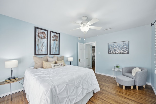 bedroom with dark wood-type flooring and ceiling fan