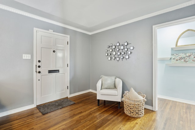 entrance foyer featuring crown molding and wood-type flooring