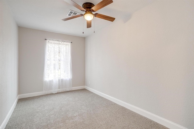 spare room featuring ceiling fan and carpet