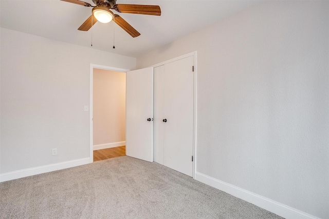 unfurnished bedroom with light colored carpet, ceiling fan, and a closet