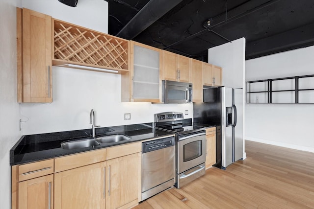 kitchen featuring stainless steel appliances, sink, light hardwood / wood-style flooring, and light brown cabinets