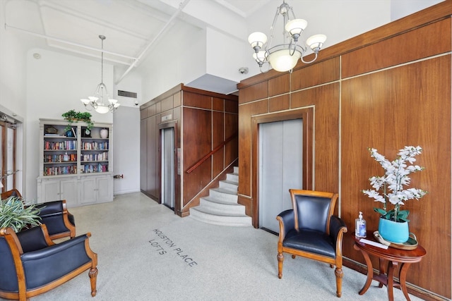 sitting room featuring beamed ceiling, a towering ceiling, and an inviting chandelier