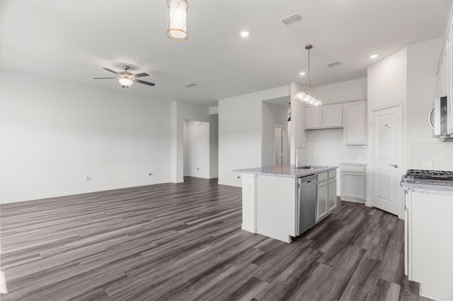 kitchen with a kitchen island with sink, hanging light fixtures, white cabinetry, stainless steel appliances, and dark hardwood / wood-style floors