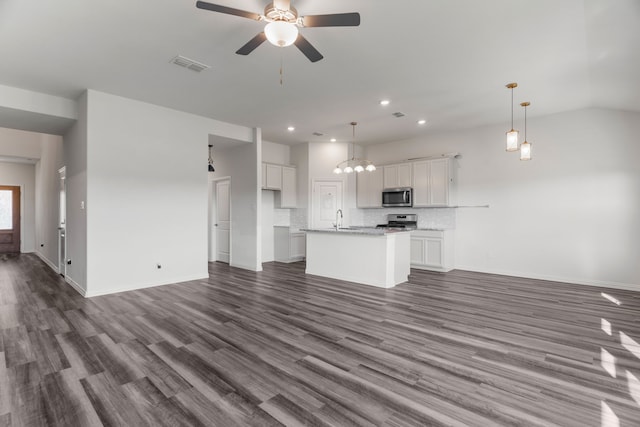 unfurnished living room featuring vaulted ceiling, sink, dark wood-type flooring, and ceiling fan