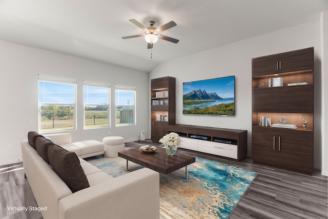 living room featuring dark hardwood / wood-style flooring, vaulted ceiling, and ceiling fan