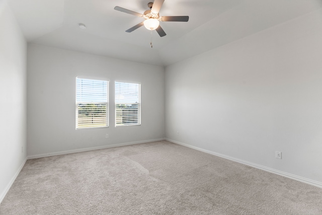 carpeted empty room with vaulted ceiling and ceiling fan