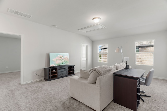 carpeted living room with vaulted ceiling