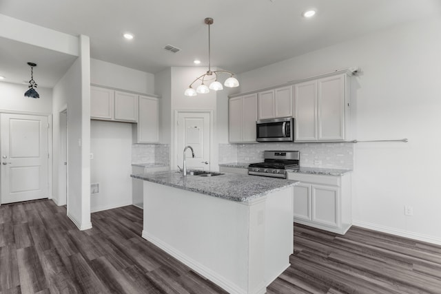 kitchen featuring light stone counters, appliances with stainless steel finishes, sink, and white cabinets