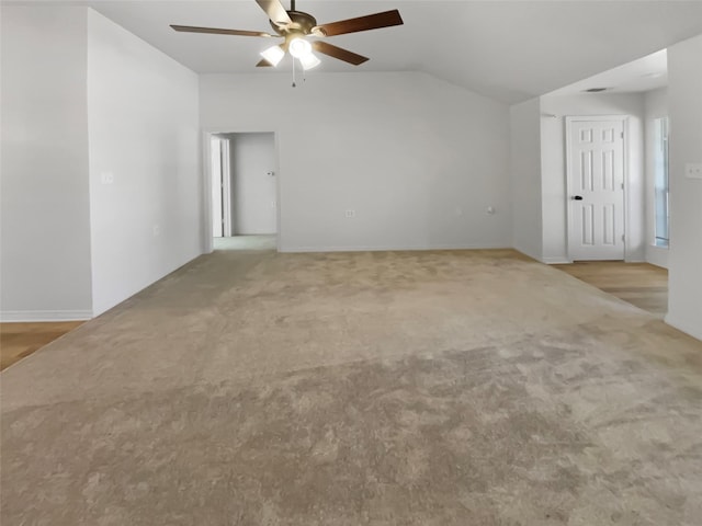 carpeted empty room featuring lofted ceiling and ceiling fan