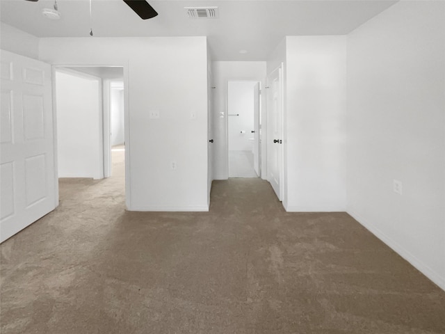 carpeted spare room featuring ceiling fan