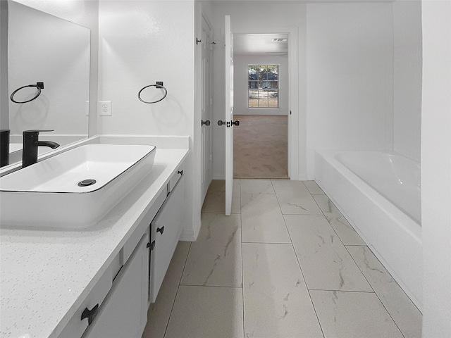 bathroom featuring vanity and a bath