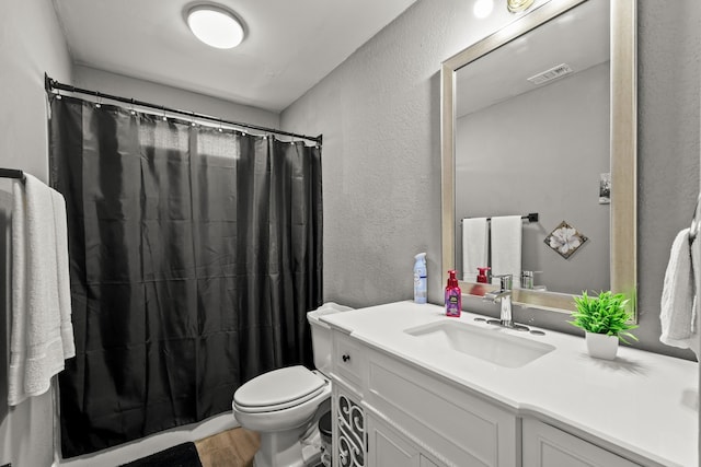 bathroom featuring a shower with curtain, vanity, wood-type flooring, and toilet