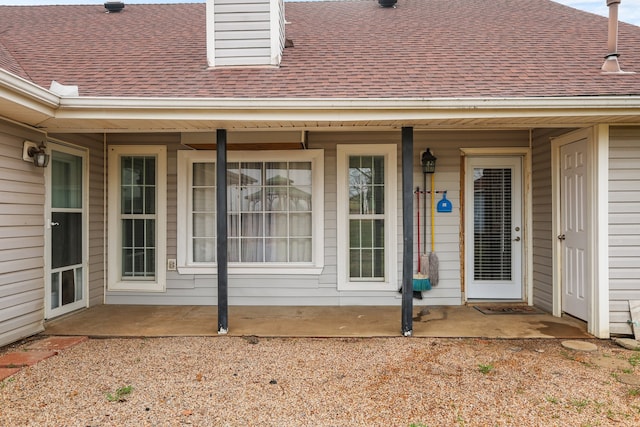 view of exterior entry with a patio