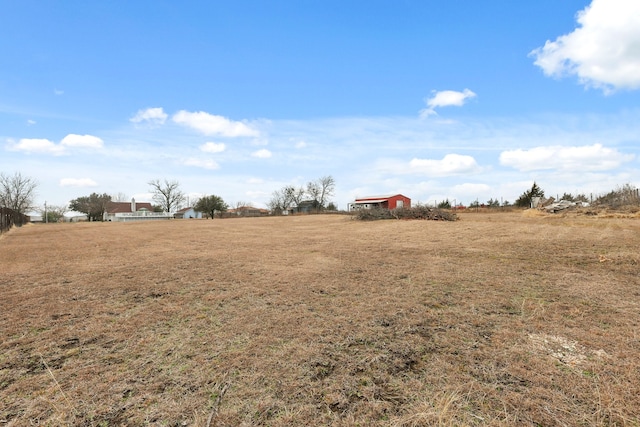 view of yard with a rural view