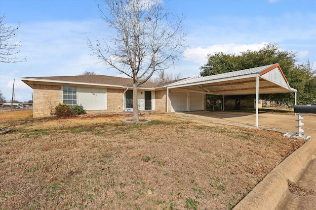 single story home featuring a carport, a garage, and a front lawn