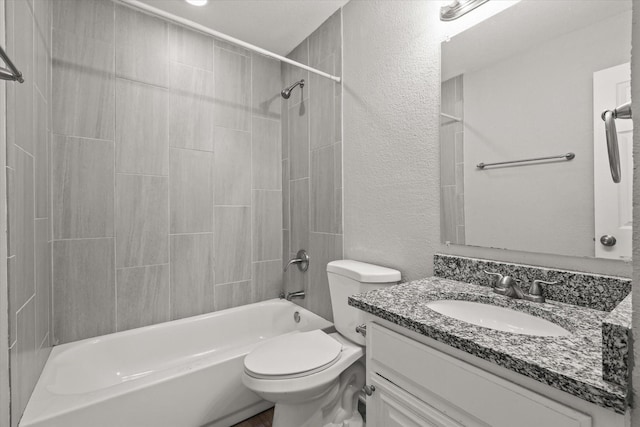 full bathroom with vanity, toilet, and tiled shower / bath combo