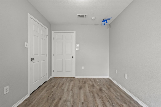 spare room with hardwood / wood-style floors