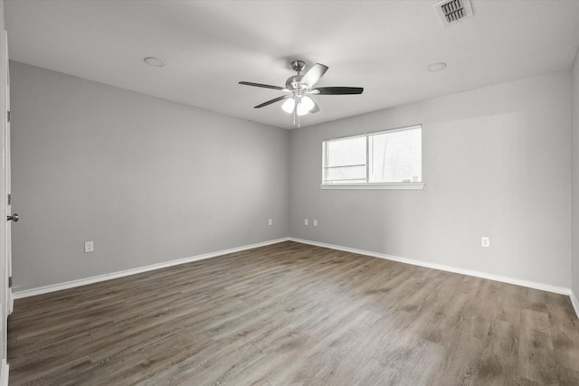 spare room with wood-type flooring and ceiling fan