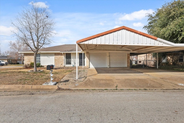 view of front of house with a garage and a carport