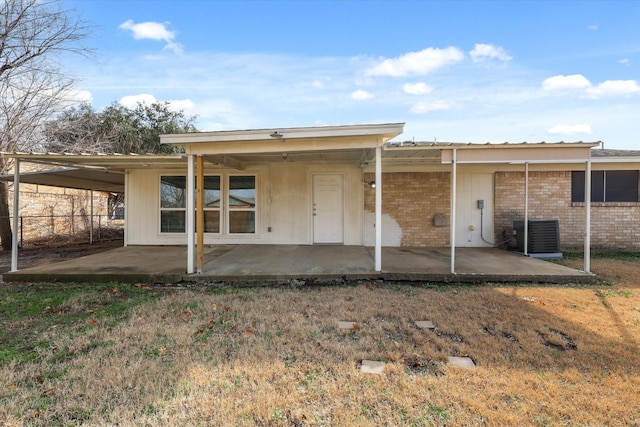 back of property with central AC unit and a patio area