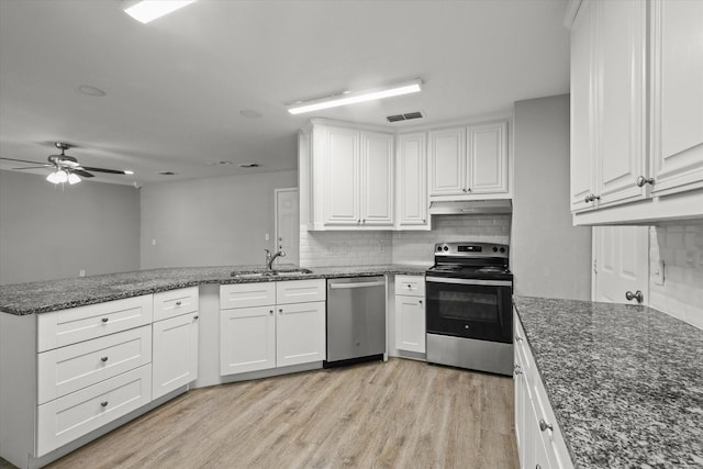 kitchen with stainless steel appliances, white cabinetry, sink, and light hardwood / wood-style floors