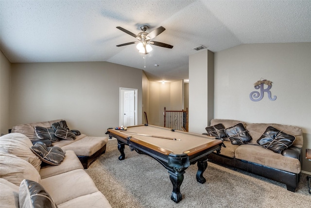 recreation room with ceiling fan, carpet floors, vaulted ceiling, and a textured ceiling