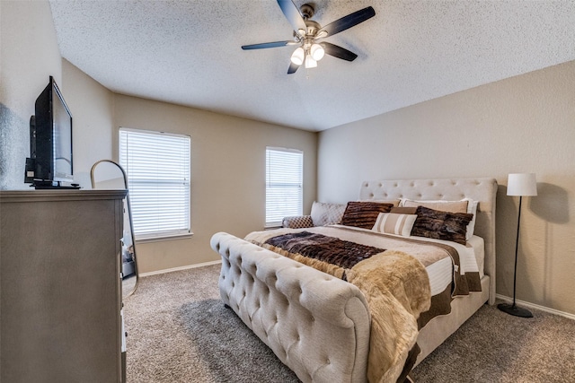 bedroom with ceiling fan, carpet floors, and a textured ceiling