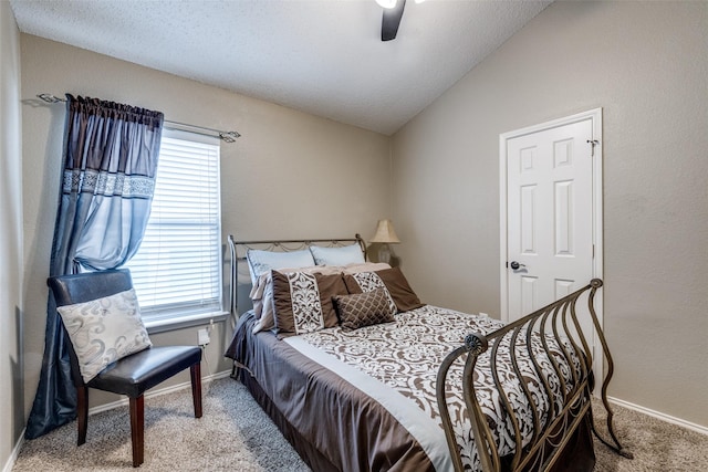 carpeted bedroom featuring vaulted ceiling, a textured ceiling, and ceiling fan