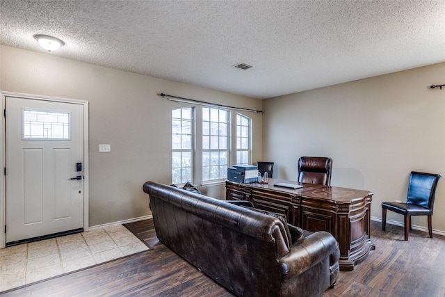 living room featuring dark hardwood / wood-style floors and a textured ceiling