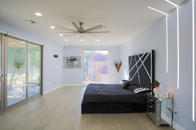 bedroom featuring hardwood / wood-style floors, access to outside, and ceiling fan