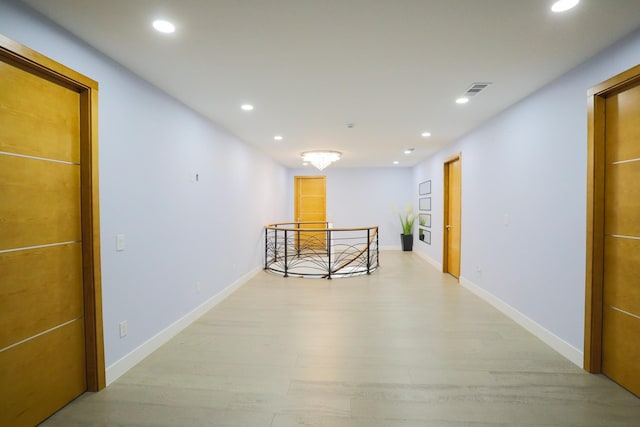 hall with light hardwood / wood-style floors