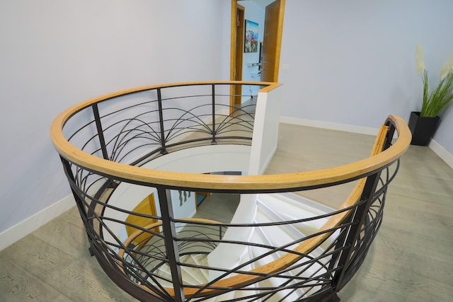 stairs featuring hardwood / wood-style flooring