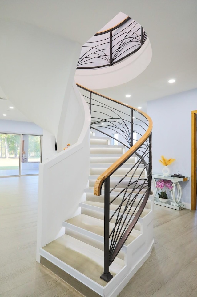 staircase featuring wood-type flooring