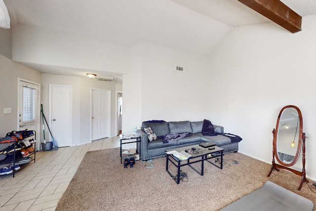 living room with light tile patterned floors and vaulted ceiling with beams