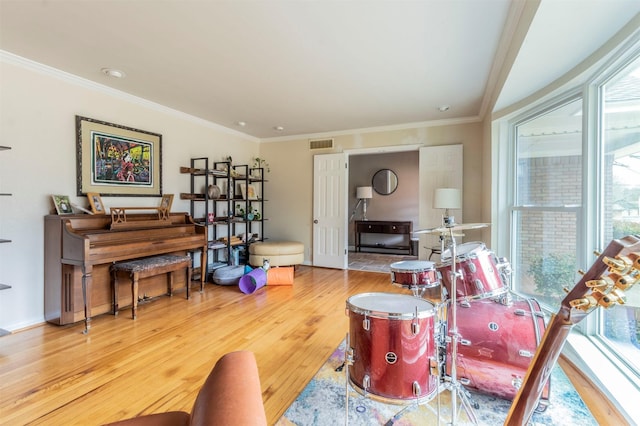 sitting room featuring ornamental molding, wood finished floors, visible vents, and baseboards