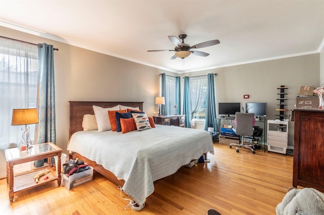 bedroom with ceiling fan, ornamental molding, and wood finished floors