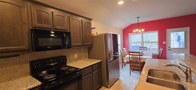 kitchen featuring lofted ceiling, a sink, hanging light fixtures, black appliances, and backsplash