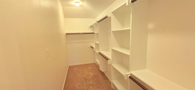 bathroom with a stall shower, vanity, baseboards, and tile patterned floors