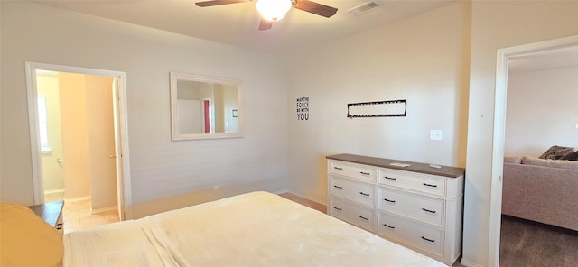 tiled bedroom with ceiling fan, visible vents, and baseboards