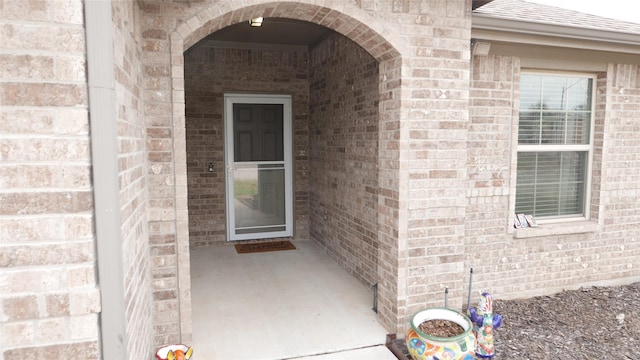 view of exterior entry featuring a patio area