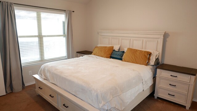 carpeted bedroom with ceiling fan and baseboards