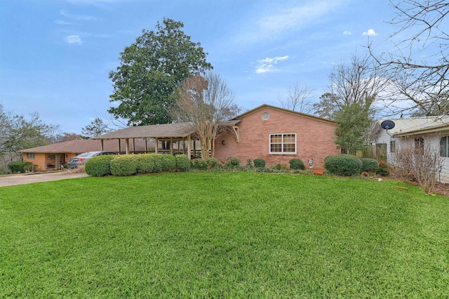 ranch-style house with a front yard and brick siding