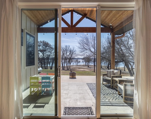 entryway with lofted ceiling, wooden ceiling, and plenty of natural light