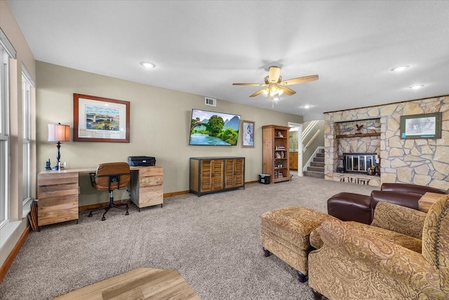 living room with ceiling fan, a fireplace, and carpet floors