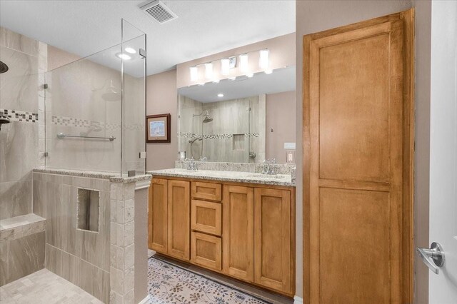 bathroom featuring vanity and a tile shower