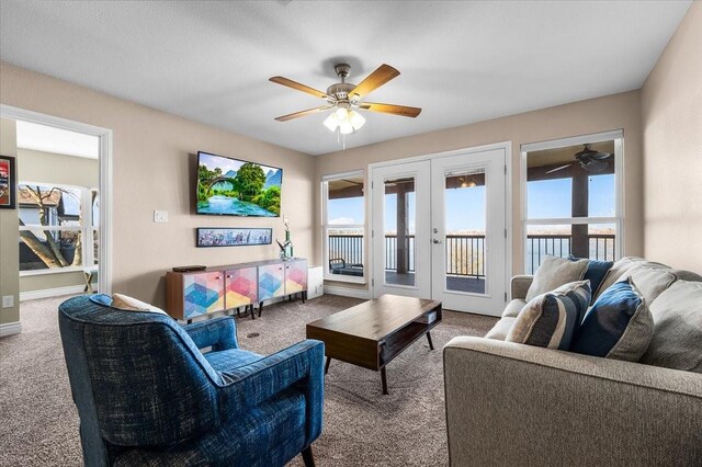 living room with french doors, ceiling fan, carpet floors, and a wealth of natural light