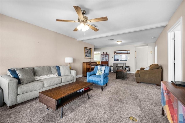 carpeted living room featuring visible vents, ceiling fan, and baseboards