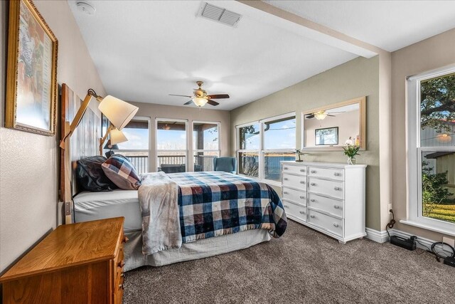 bedroom featuring ceiling fan and dark carpet