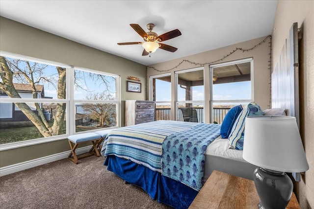 carpeted bedroom featuring a ceiling fan and baseboards