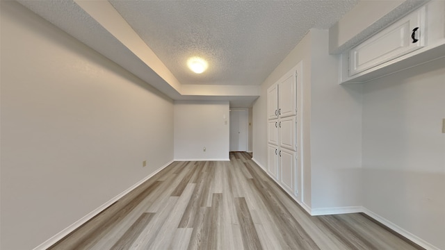 interior space with a textured ceiling and light wood-type flooring